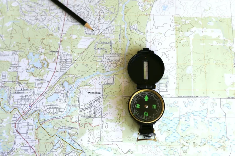 A topographic map with a compass and a pencil