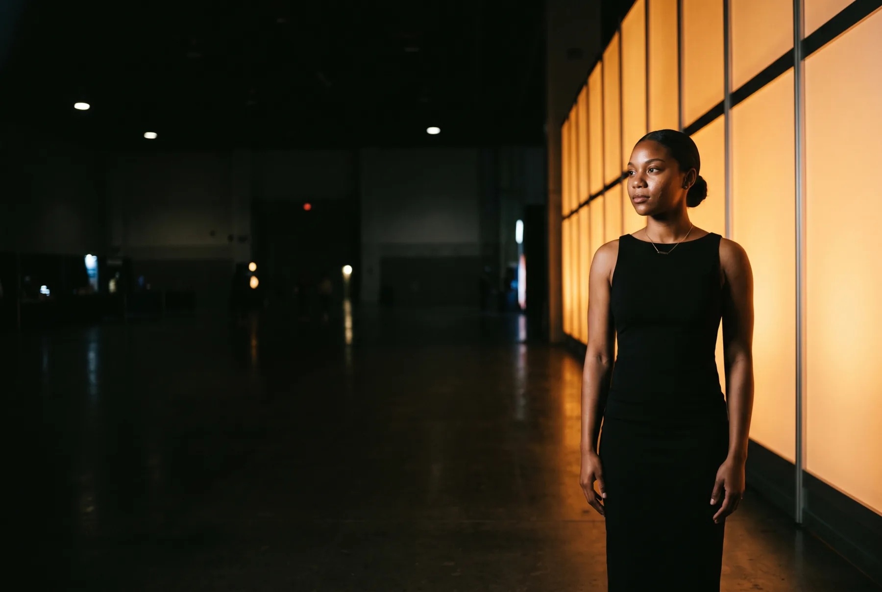 Simone Vance at a launch, lit by the brand wall